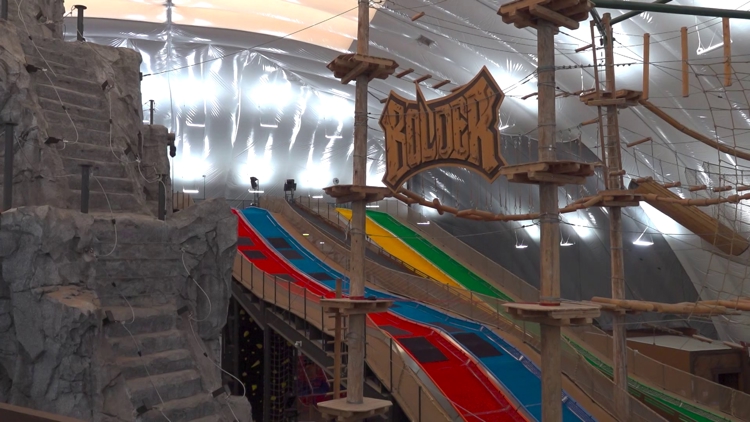 A sunset view of Bolder Adventure Park in Grand Prairie, Texas, showcasing its vibrant attractions.